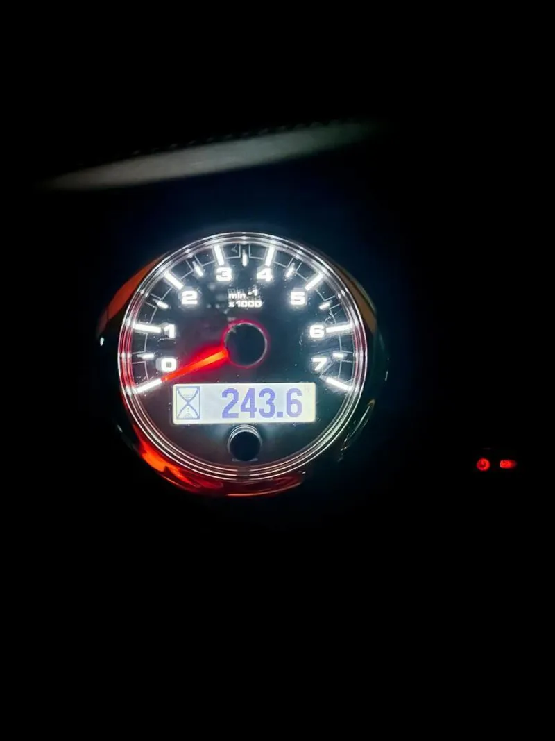 Slide: The Image of Close-up of Bryant Calandra 23 tachometer displaying 243.6 RPM, illuminated in dark setting. - 11