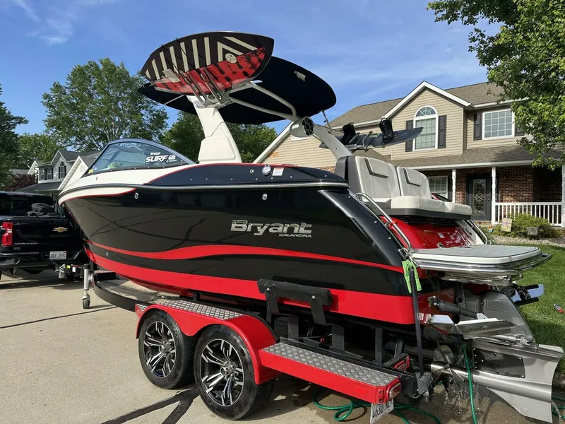 Slide: The Image of 2018 Bryant Calandra 23 boat on trailer, parked in residential driveway, with wakeboard rack. - 3