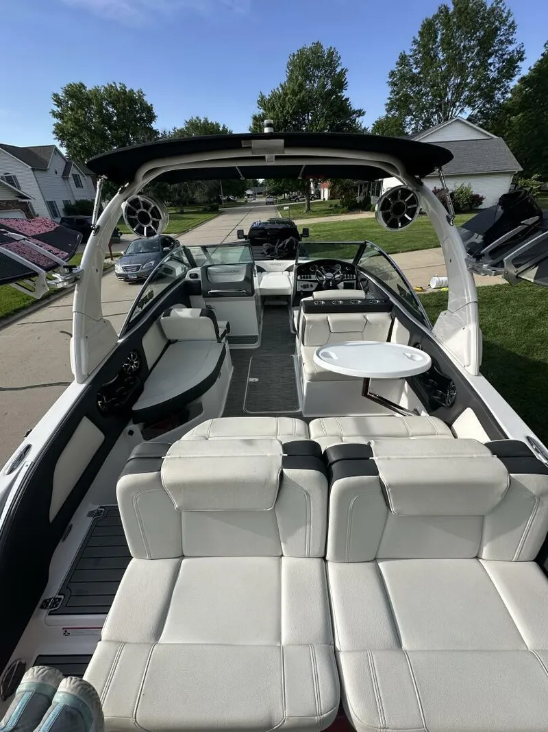 Slide: The Image of 2018 Bryant Calandra 23 boat with spacious seating and modern design in a residential area. - 6
