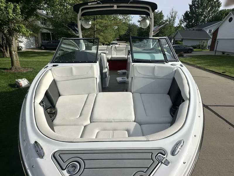 Slide: The Image of 2018 Bryant Calandra 23 boat with spacious seating, parked in a suburban driveway. - 7