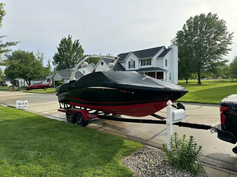 Slide: The Image of 2018 Bryant Calandra 23 boat on trailer in suburban driveway. - 8