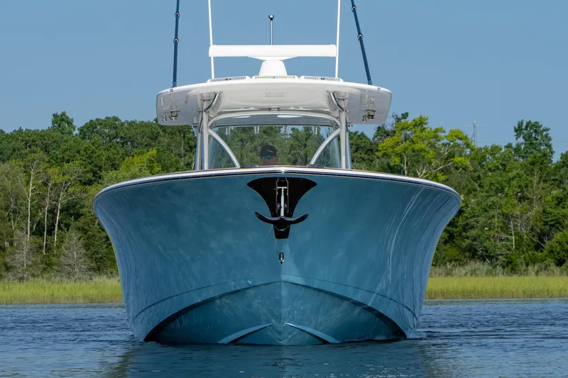 Slide: The Image of 2025 Valhalla Boatworks V-41 on water, front view, with lush greenery background. - 1