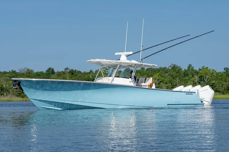Slide: The Image of 2025 Valhalla Boatworks V-41 in blue, cruising on calm water with fishing rods. - 12