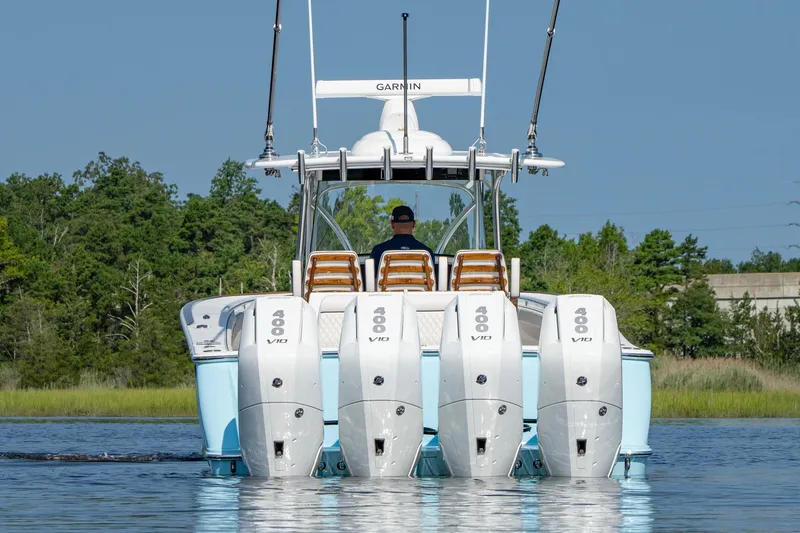Slide: The Image of 2025 Valhalla Boatworks V-41 with quad 400 V10 engines on a serene waterway. - 21
