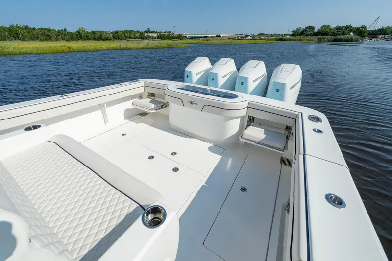 Slide: The Image of 2025 Valhalla Boatworks V-41 with quad Mercury engines on a serene waterway. - 27