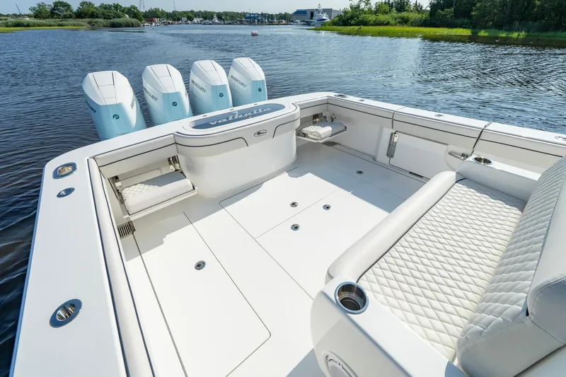 Slide: The Image of 2025 Valhalla Boatworks V-41 with quad Mercury engines on a serene lake. - 28
