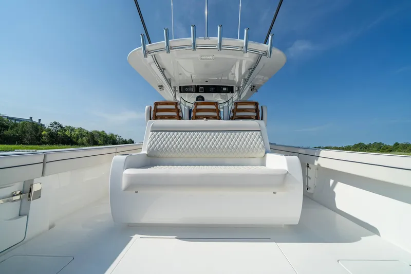 Slide: The Image of 2025 Valhalla Boatworks V-41, luxurious seating, clear blue sky, sleek design. - 30