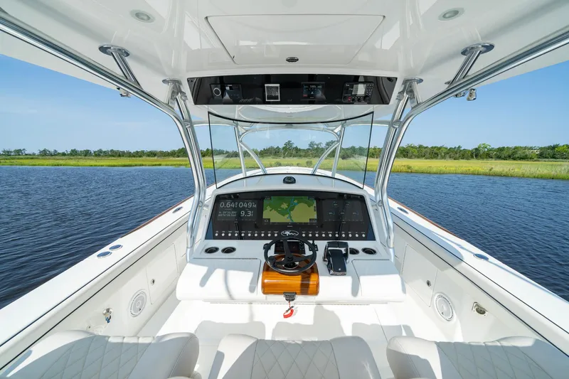 Slide: The Image of 2025 Valhalla Boatworks V-41 helm with advanced navigation system on calm water. - 33