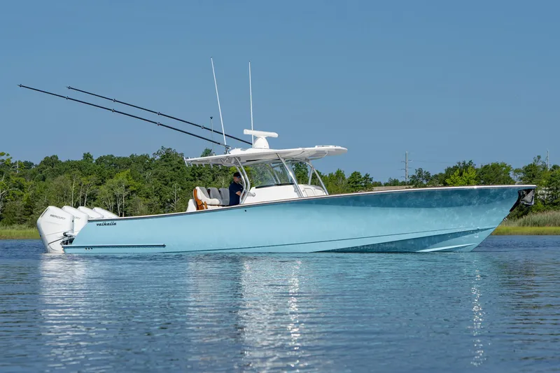 Slide: The Image of 2025 Valhalla Boatworks V-41 in blue, cruising on calm water with fishing rods. - 8
