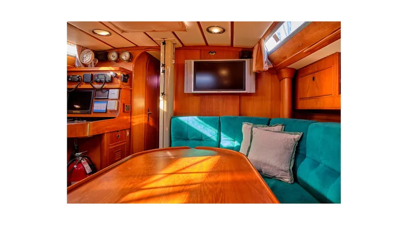 Slide: The Image of Sailboat deck with solar panel, Wauquiez Centurion 45, docked in marina, clear blue sky. - 46