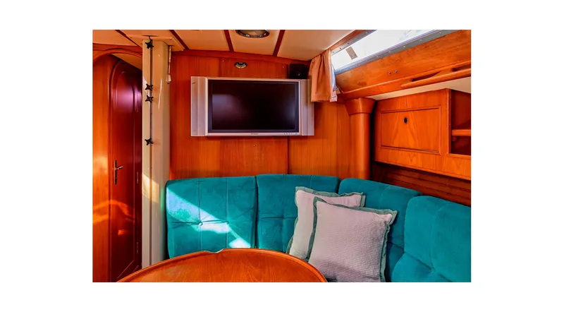 Slide: The Image of Interior of 1992 Wauquiez Centurion 45 yacht with teal seating and wooden finishes. - 47