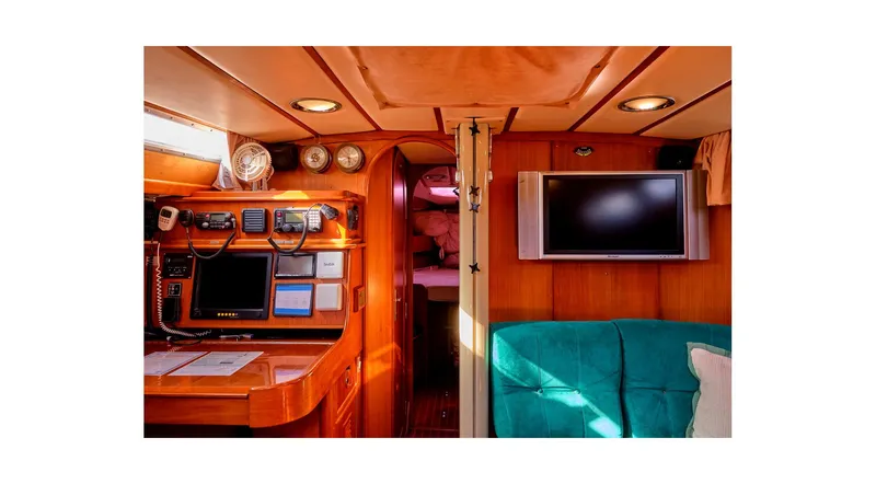 Slide: The Image of Interior of 1992 Wauquiez Centurion 45 yacht with teal seating and wall-mounted TV. - 48