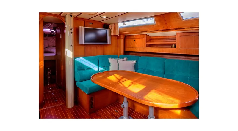 Slide: The Image of Interior of 1992 Wauquiez Centurion 45 yacht with navigation station and cozy seating area. - 49