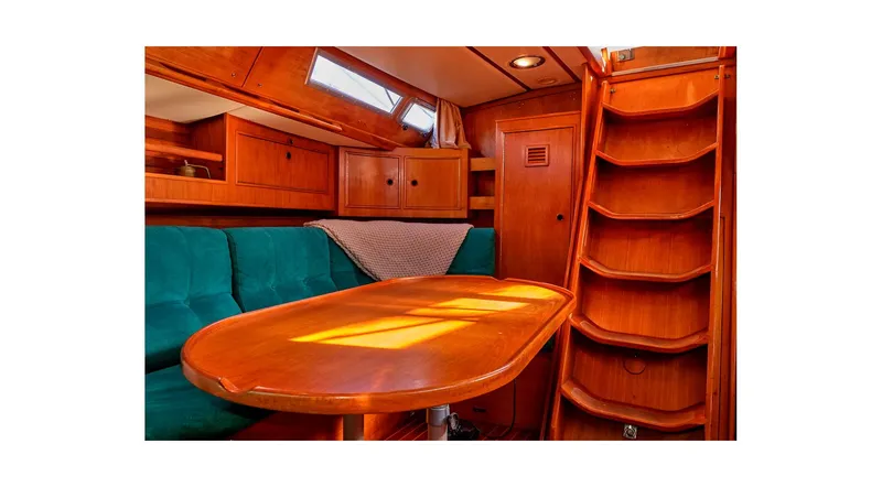 Slide: The Image of Interior of 1992 Wauquiez Centurion 45 yacht with teal seating and wooden table. - 50