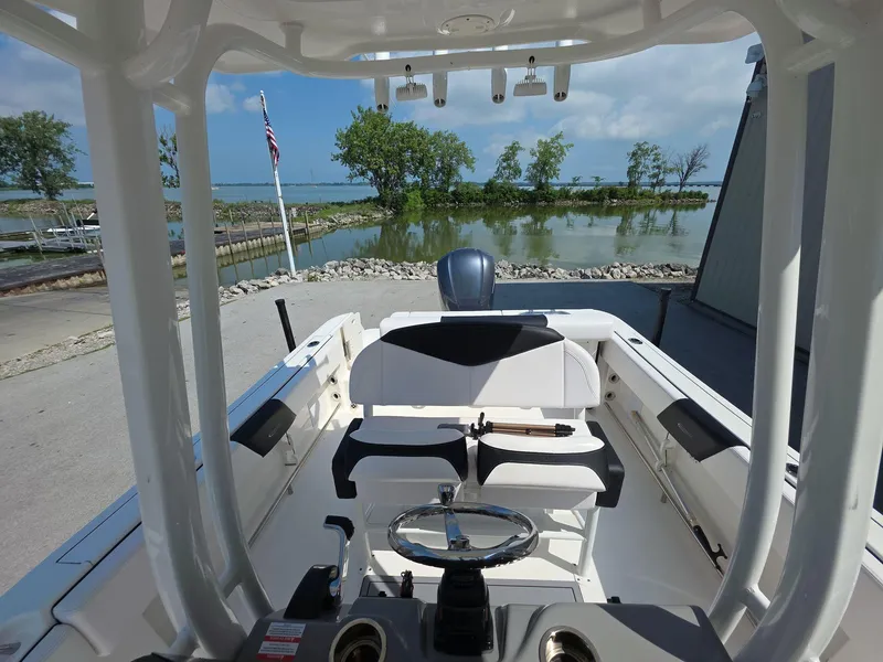 Slide: The Image of 2021 Robalo R242 Center Console boat interior with scenic waterfront view. - 12