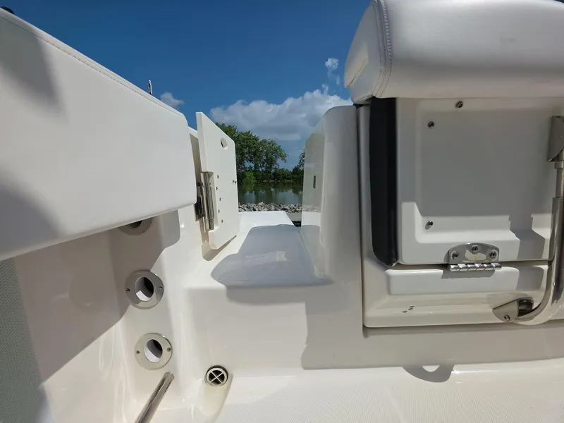 Slide: The Image of 2021 Robalo R242 Center Console boat interior with seating and storage compartments. - 18