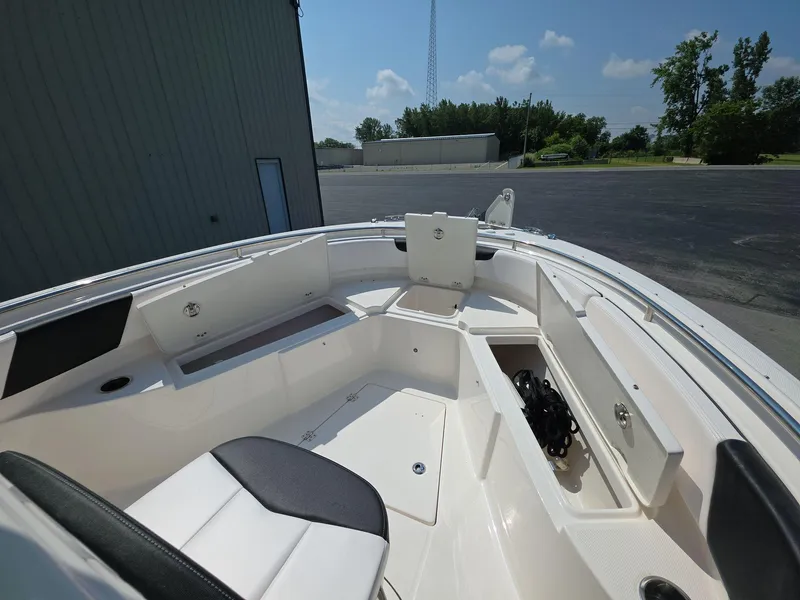 Slide: The Image of 2021 Robalo R242 Center Console boat interior with seating and storage compartments. - 19