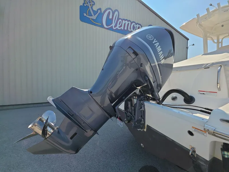 Slide: The Image of 2021 Robalo R242 Center Console with Yamaha outboard motor, displayed at Clemons Boats. - 7
