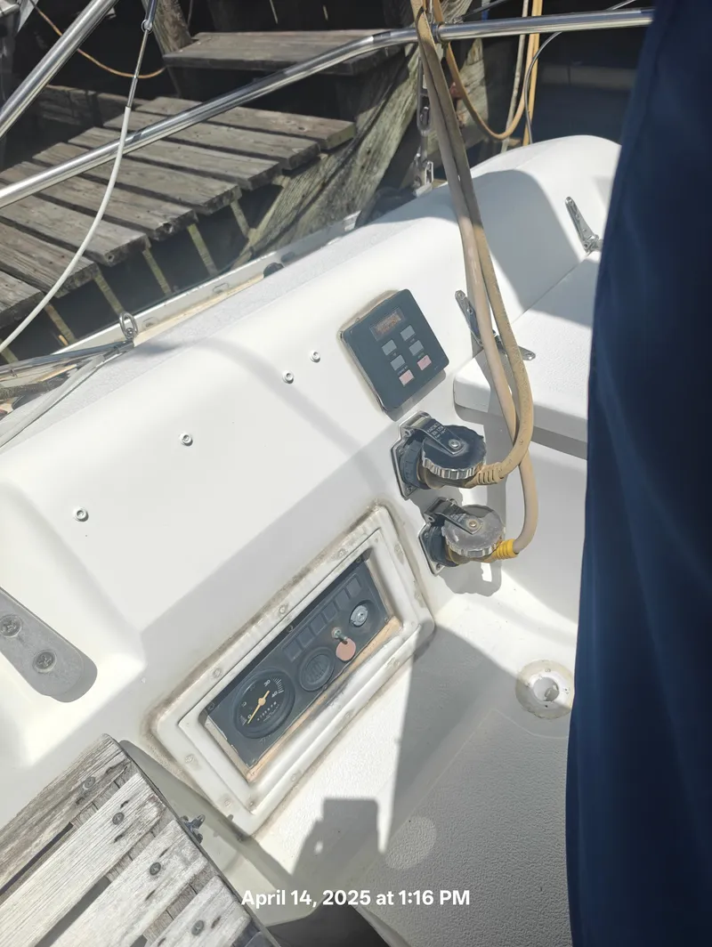 Slide: The Image of Cockpit controls of a 1984 Hunter 40 sailboat, featuring gauges and winches. - 11