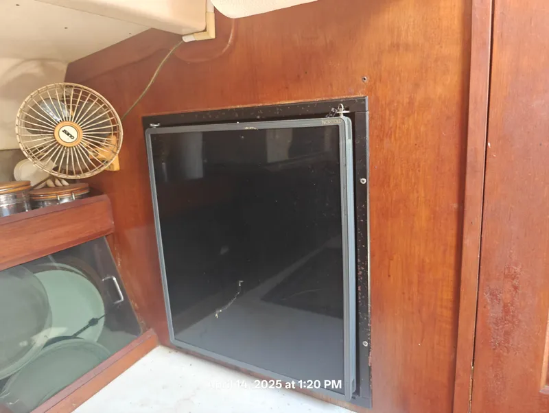 Slide: The Image of Interior of 1984 Hunter 40 sailboat with fan and storage cabinet. - 18