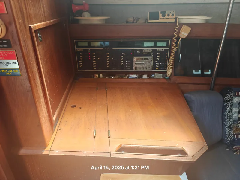 Slide: The Image of Interior of 1984 Hunter 40 sailboat with navigation panel and wooden table. - 21