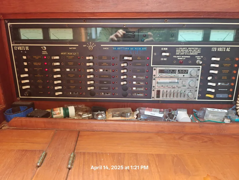 Slide: The Image of Electrical control panel on a 1984 Hunter 40 sailboat, featuring switches and meters. - 22