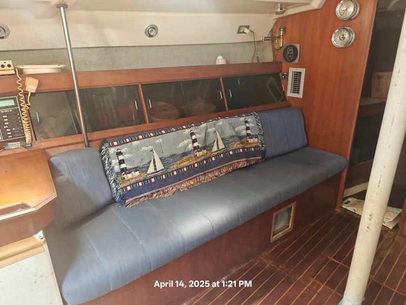 Slide: The Image of Interior of 1984 Hunter 40 sailboat with blue seating and nautical-themed decor. - 24