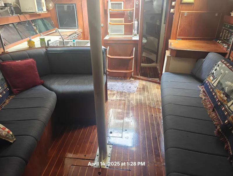 Slide: The Image of Interior of a 1984 Hunter 40 sailboat with cozy seating and wooden flooring. - 33