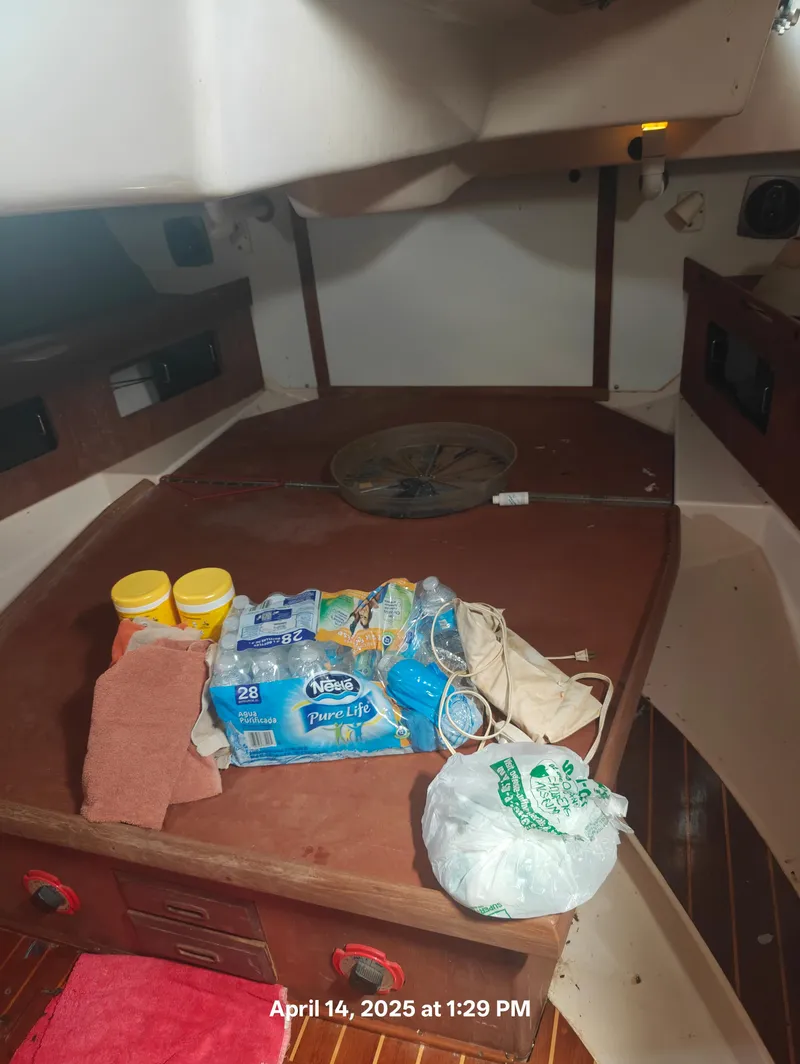 Slide: The Image of Interior of 1984 Hunter 40 sailboat with supplies on a wooden surface. - 37