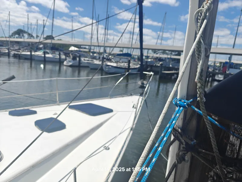 Slide: The Image of Sailboat docked at marina, Hunter 40 model, 1984, with ropes and clear sky. - 4