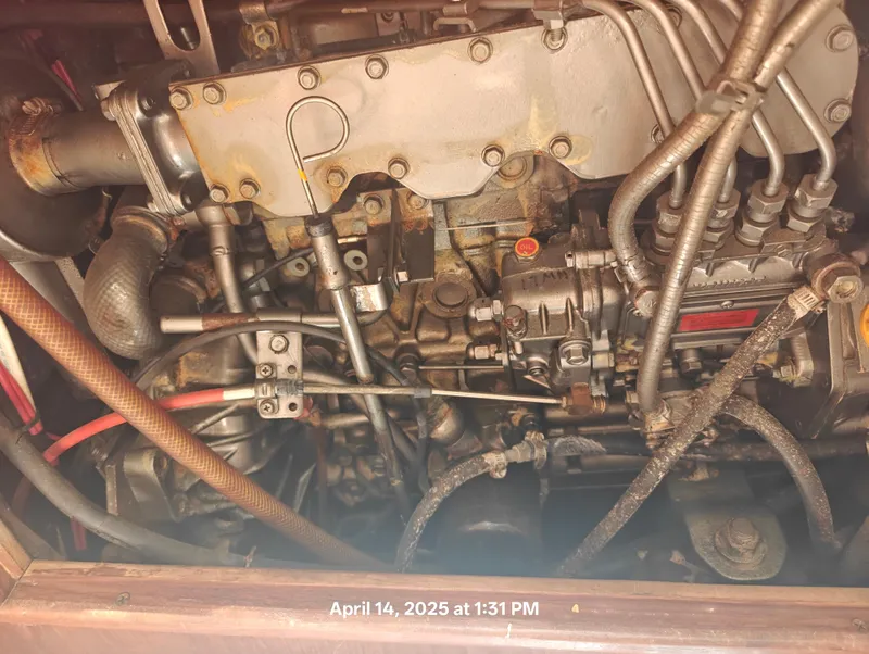 Slide: The Image of Close-up of a 1984 Hunter 40 engine with visible pipes and components. - 41