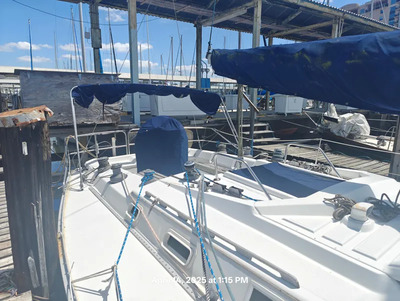 Slide: The Image of Sailboat docked at marina, Hunter 40 model, 1984, with blue covers and clear sky. - 6