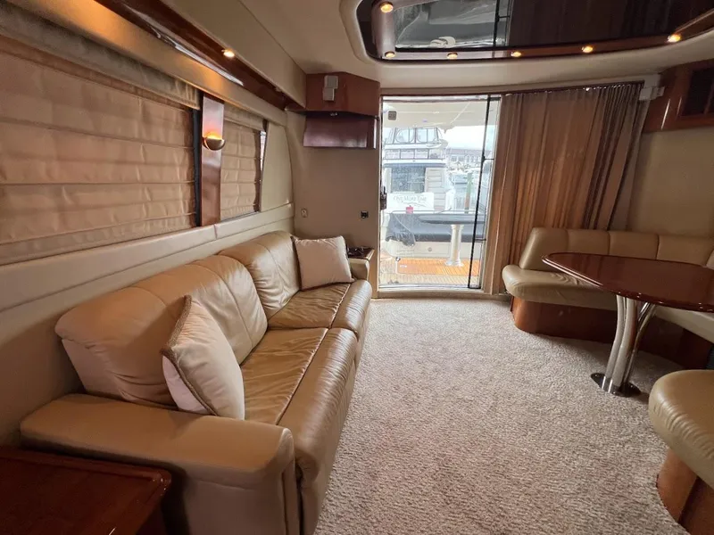 Slide: The Image of Luxurious interior of a 2006 Carver 56 Voyager yacht with plush seating and elegant decor. - 11