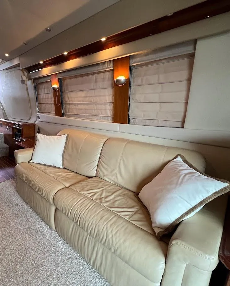 Slide: The Image of Luxurious interior of 2006 Carver 56 Voyager yacht with beige leather sofa and elegant lighting. - 12
