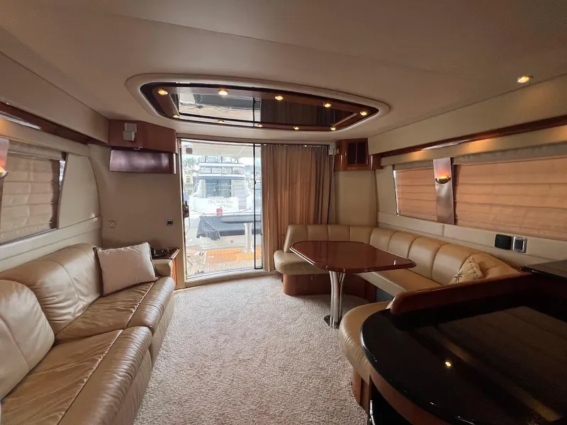 Slide: The Image of Luxurious interior of a 2006 Carver 56 Voyager yacht with elegant seating and dining area. - 13