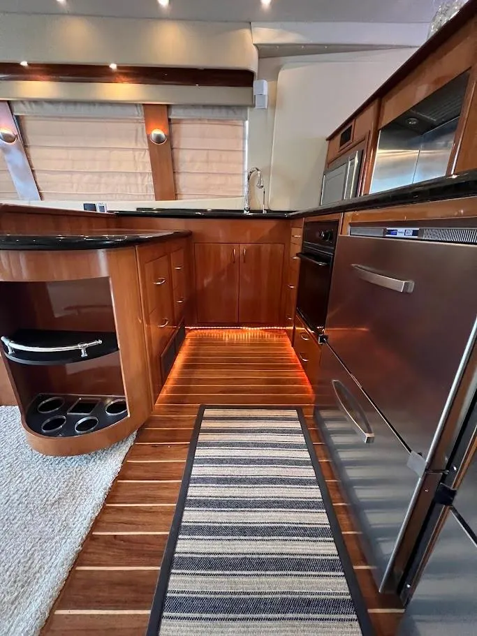 Slide: The Image of Luxurious kitchen interior of 2006 Carver 56 Voyager yacht with wood cabinetry and modern appliances. - 15