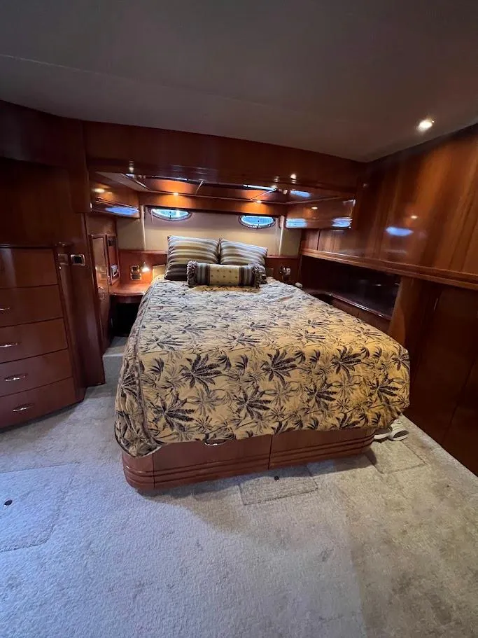 Slide: The Image of Luxurious bedroom interior of 2006 Carver 56 Voyager yacht with elegant wood finish. - 20