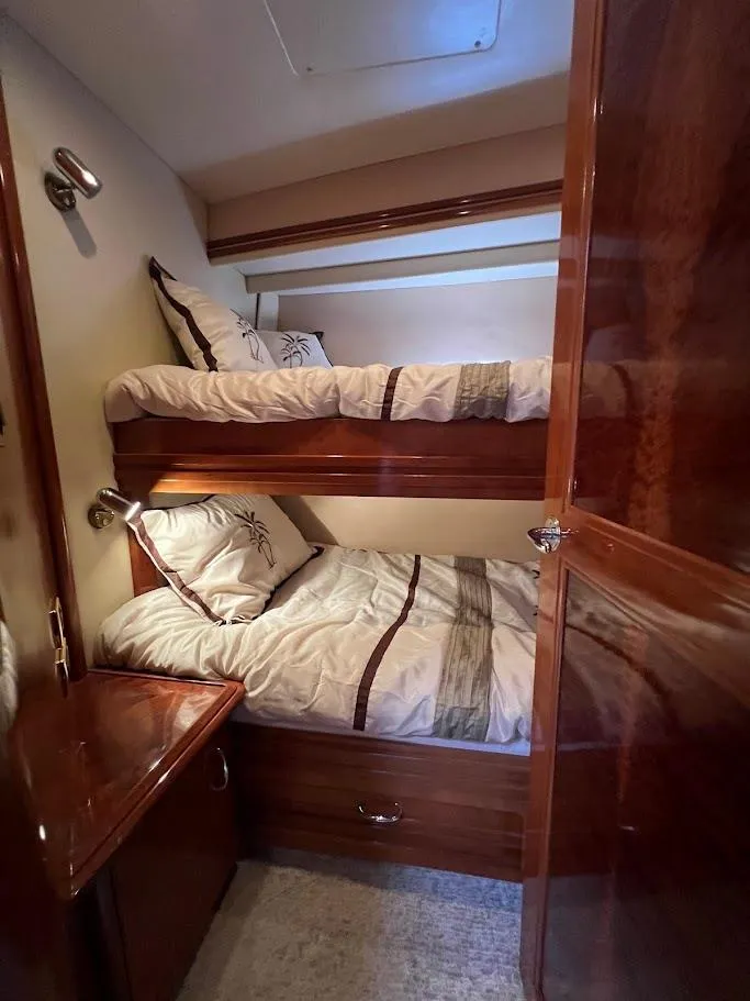 Slide: The Image of Bunk beds in 2006 Carver 56 Voyager yacht cabin with wooden interior. - 26