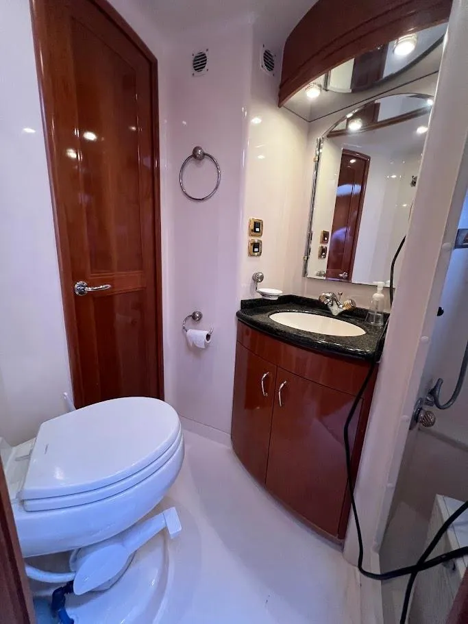 Slide: The Image of Luxurious bathroom in 2006 Carver 56 Voyager yacht with wooden cabinetry and modern fixtures. - 27
