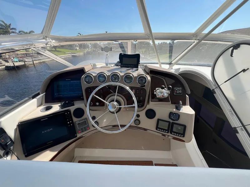Slide: The Image of Helm of 2006 Carver 56 Voyager yacht with navigation instruments and steering wheel. - 29