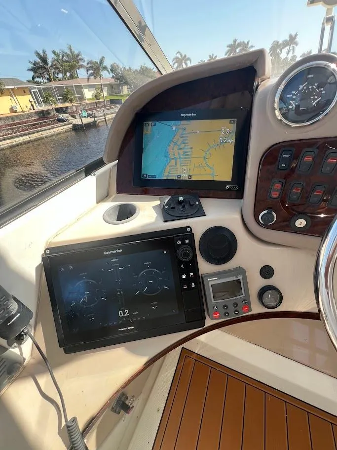 Slide: The Image of 2006 Carver 56 Voyager helm with navigation screens and controls, dockside view. - 30