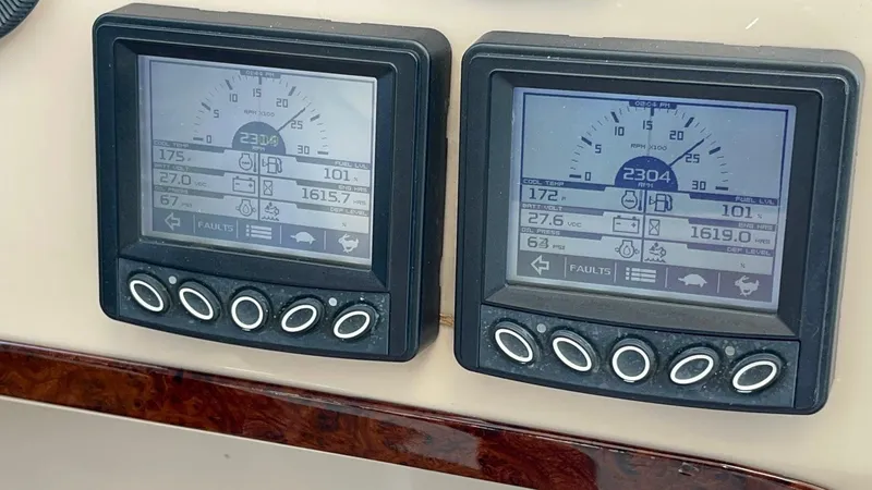 Slide: The Image of Digital gauges on a 2006 Carver 56 Voyager yacht dashboard displaying engine metrics. - 32