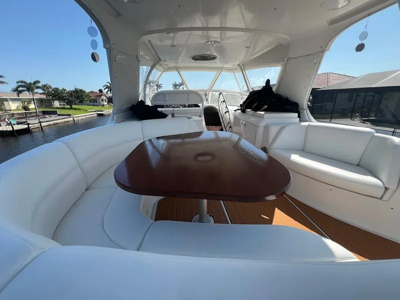 Slide: The Image of Luxurious interior of 2006 Carver 56 Voyager yacht with white seating and wooden table. - 38