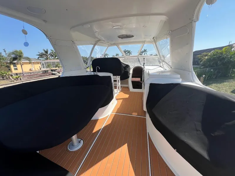 Slide: The Image of Spacious deck of 2006 Carver 56 Voyager yacht with covered seating and wooden flooring. - 40