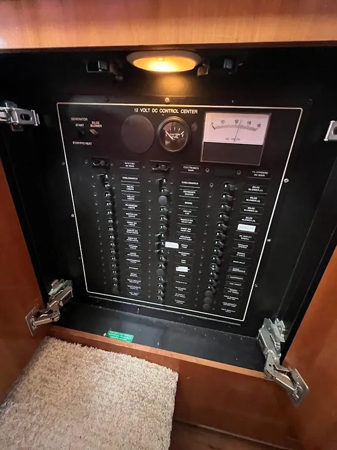 Slide: The Image of Electrical control panel in a 2006 Carver 56 Voyager yacht, featuring switches and gauges. - 43