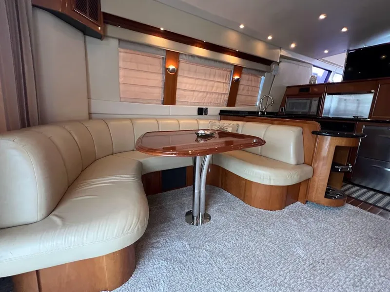 Slide: The Image of Luxurious interior of 2006 Carver 56 Voyager yacht with plush seating and modern kitchen. - 7