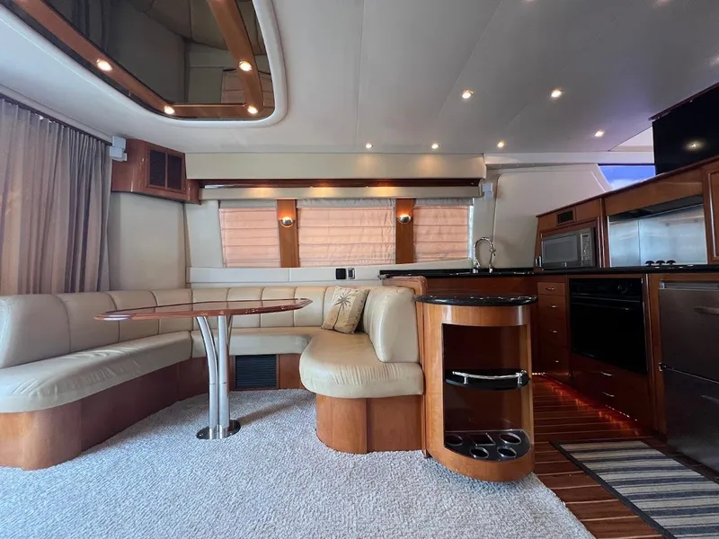Slide: The Image of Luxurious interior of a 2006 Carver 56 Voyager yacht with elegant seating and modern kitchen amenities. - 9