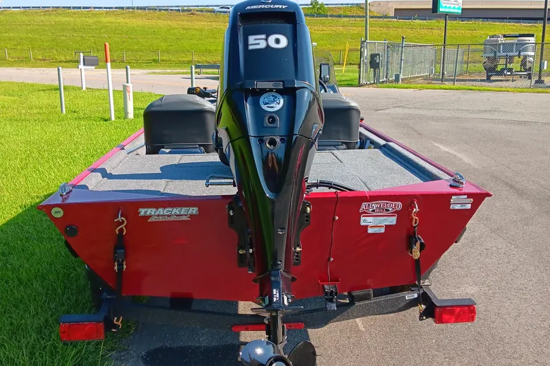 Slide: The Image of 2026 Tracker Bass Tracker Classic XL boat with Mercury 50 engine, parked on pavement. - 3