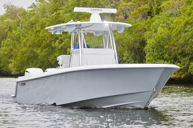 Slide: The Image of 2026 Contender 32 ST boat cruising on a calm river, surrounded by lush greenery. - 10