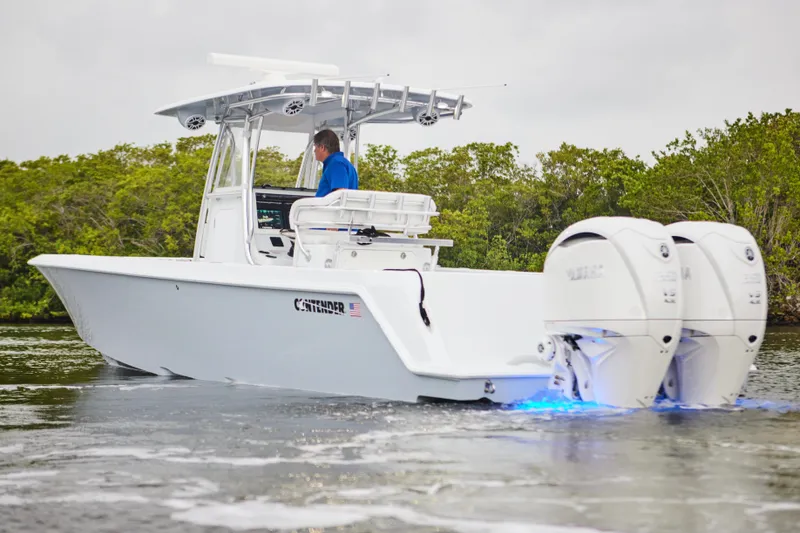 Slide: The Image of 2026 Contender 32 ST boat with dual engines cruising on water. - 11